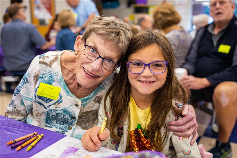 A family smiles at Winstead Elementary's Grandparents Breakfast